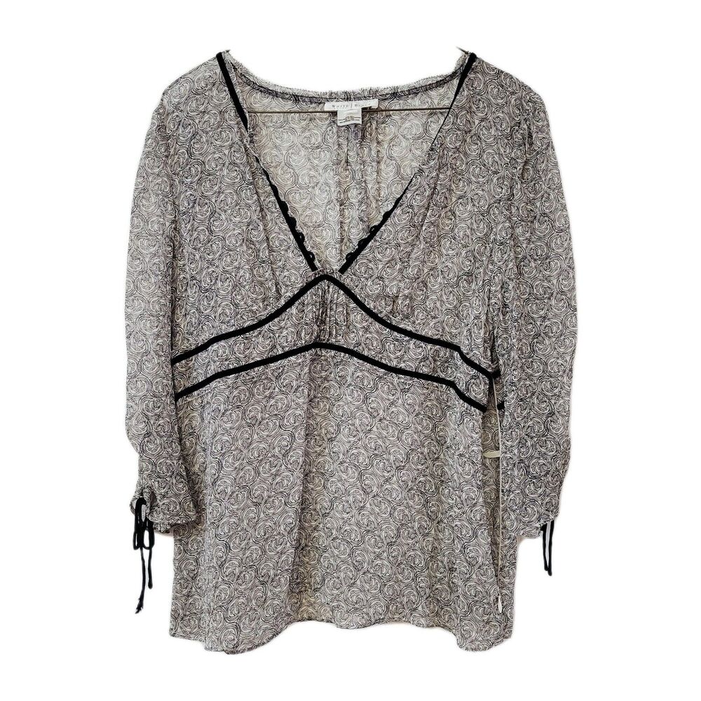 Elegant sheer blouse by White House Black Market, made from 100% silk.